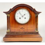 An Edwardian inlaid mahogany 8-day mantle clock, the enamel dial with black Arabic numerals