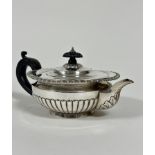 A Victorian London silver half lobed morning teapot with ebony carved knop and handle to side,