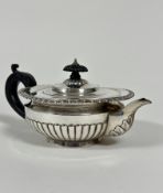 A Victorian London silver half lobed morning teapot with ebony carved knop and handle to side,