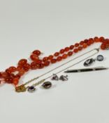 A carnelian graduated bead necklace (a/f), a gilt metal chain with paste set citrine coloured
