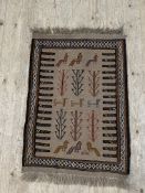 A North African? flat weave rug, decorated with stylised camels and birds, 62cm x 97cm