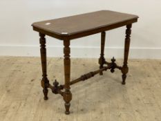 A late Victorian mahogany window table, the rectangular top with canted corners raised on turned