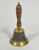An Edwardian brass ash handled turned school bell, with turned knop and patinated centre panel (25cm