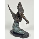 A San Pacific International American patinated cast bronze pelican figure mounted on hardwood