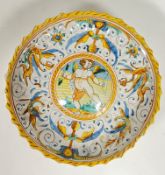 A late 19th century Italian maiolica tin-glazed Istoriato pottery stemmed bowl depicting Cupid in