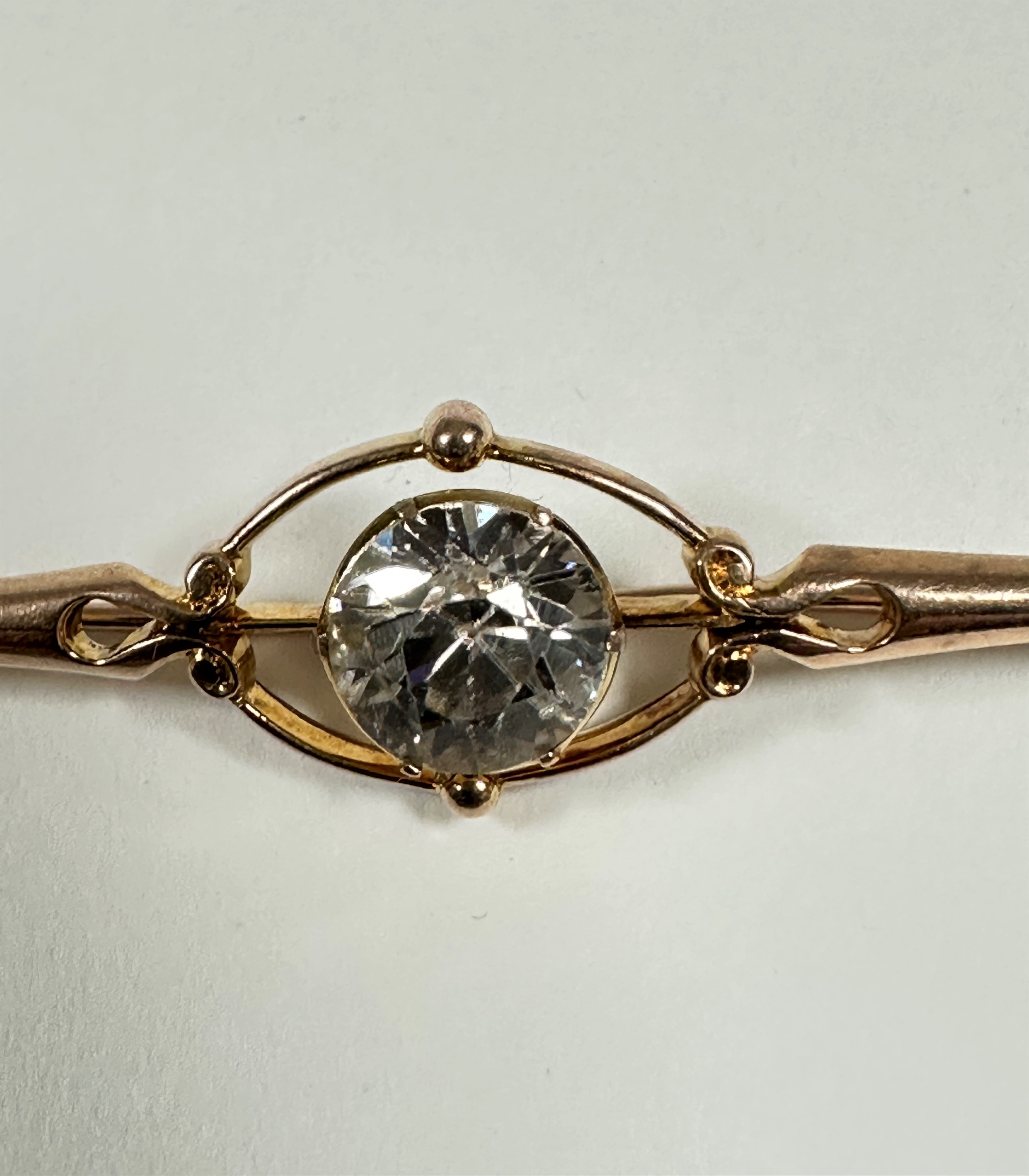 An unmarked but tested 9ct gold Edwardian bar brooch set natural zircon (1.5ct), with open oval - Image 2 of 3