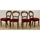 A set of four Victorian mahogany balloon back dining chairs with upholstered seats and turned