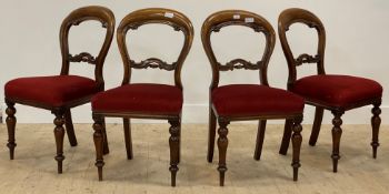 A set of four Victorian mahogany balloon back dining chairs with upholstered seats and turned