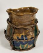 A Japanese pottery storage jar with bamboo strapping decorated with stylised iris and leaf design,