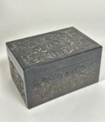 A Sri Lankan rectangular ebony box, the top with relief carved figure enclosed within a lotus flower