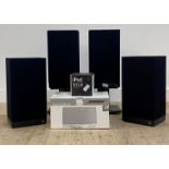 A set of four speakers by KEF, two with stands, together with a bose sound dock in original box, and