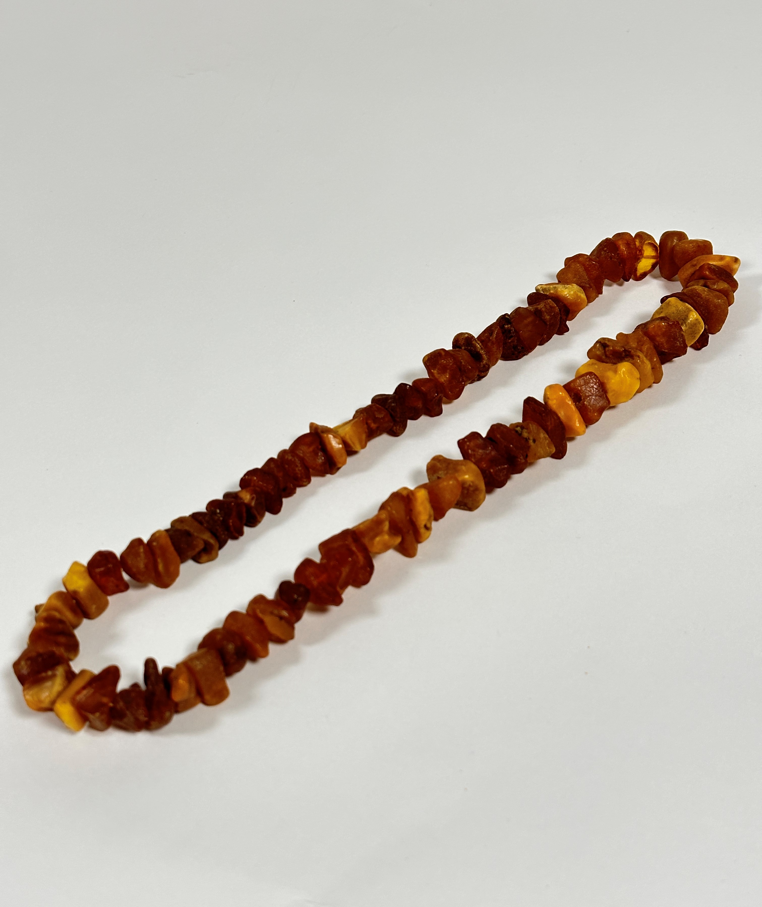 A dark honey and pale honey coloured natural nugget amber necklace. 30cm
