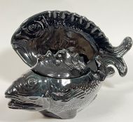 A black glazed Aegitna Vallauris tureen (h- 25cm) and platter (w- 58cm) in the form of fish (