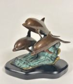 San Pacific International American cast bronze triple dolphin patinated group on mahogany base (16cm