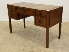 A Chinese style hardwood desk, fitted with one long and four short drawers, raised on moulded square
