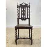 An oak high back chair of 17th century design, with oak leaf carved crest rail and splat, spiral