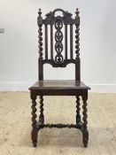 An oak high back chair of 17th century design, with oak leaf carved crest rail and splat, spiral