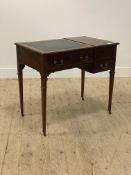 An Edwardian mahogany writing desk, the skivered top flanked by a lift up panel opening to a