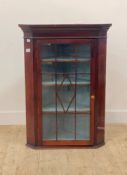 A 19th century and later mahogany wall hanging corner cabinet, with faux astragal glazed door