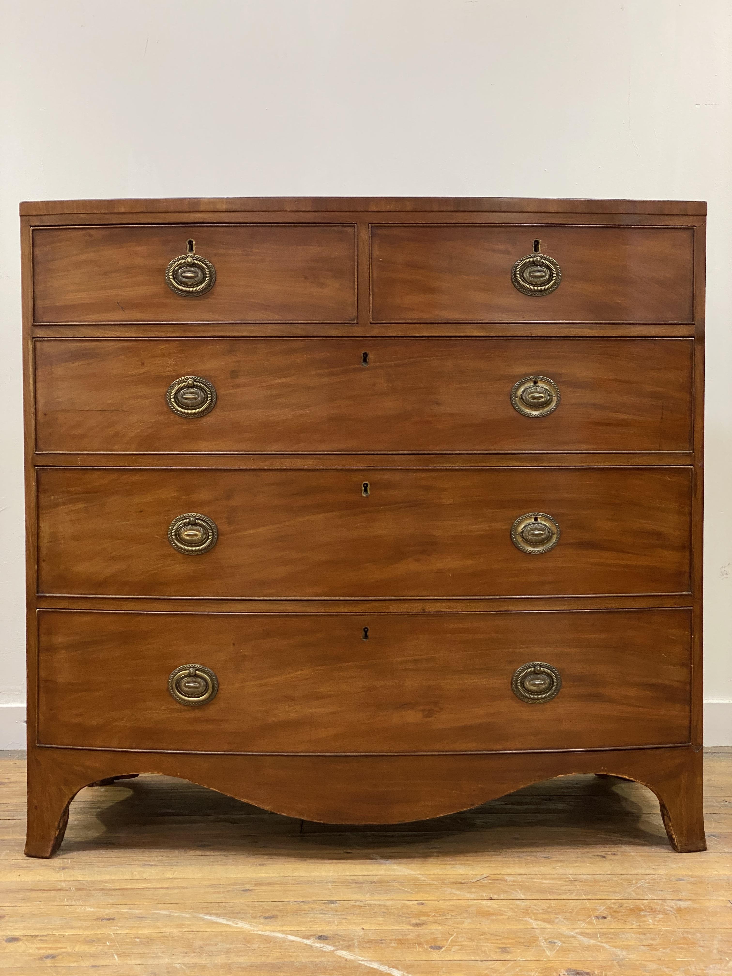 A Regency mahogany bow front chest, fitted with two short and three long graduated and cock beaded