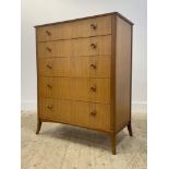 A mid century teak chest, fitted with five graduated drawers, raised on tapered supports H104cm,