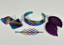 A collection of titanium jewellery including a mesh hair clip, an open tapered bangle with copper
