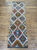 A Chobi Kilim runner rug , typically decorated. 214cm x 61cm.
