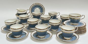 A Paragon China blue and gilt part tea set comprising twelve cups and ten saucers, a slop bowl/sugar