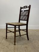 An Edwardian stained beech framed bedroom chair, double 'c' scroll to crest over spindle back,