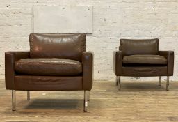 A pair of quality contemporary easy chairs, each upholstered brown leather, raised on square section