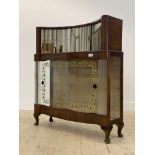 An Art Deco walnut cocktail cabinet, circa 1930's, the concave superstructure with sliding