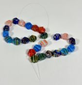 A set of twenty five Murano coloured glass cane faceted beads - partially strung, largest (2cm x