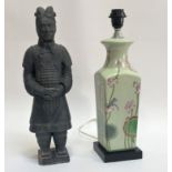 A Terracottta model Chinese warrior, in the period style (chip to base) (h- 46cm) and a ceramic