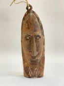A painted wooden wall mask, Papua New Guinea, with cowrie shell eyes. h.41cm