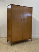 A mid century teak double wardrobe, the interior fitted for hanging, H178cm, W123cm D54cm