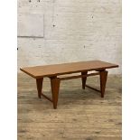 Toften, Denmark - A mid century teak coffee table, the rectangular top raised on angular supports