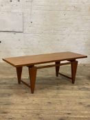 Toften, Denmark - A mid century teak coffee table, the rectangular top raised on angular supports