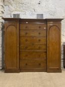 A Victorian mahogany three part combination wardrobe with inverted break front, the projecting