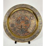 An Middle Eastern brass, white metal and copper inlaid circular plaque with Hebrew figures