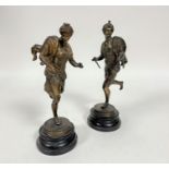 A late 19thc pair of gilded spelter Eastern figures with turbans and cloaks, the female with three