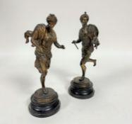 A late 19thc pair of gilded spelter Eastern figures with turbans and cloaks, the female with three