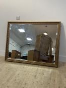 A gilt composition framed wall hanging mirror 131cm x 101cm