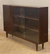McIntoch, a mid century walnut bookcase, twin sliding glass doors enclosing two adjustable