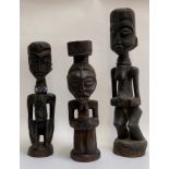 Two carved wooden fertility figures, probably Yombe, Congo, together with a carved figure of a