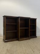 A walnut and oak break front dwarf bookcase, 20th century, fitted with five shelves, on a skirted