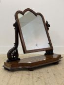 A Victorian Gothic mahogany swing mirror of large proportions, the arched frame with satinwood inlay