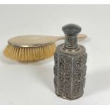 An Edwardian hammered silver hair brush (25cm) and an Eastern white metal cast open panel sided