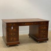 A Georgian style mahogany twin pedestal desk, the top inset with gilt brown tooled leather writing
