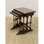A Reprodux Georgian style mahogany nest of three tables, square moulded tops inset with glass panels
