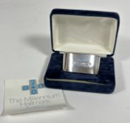 A Millennium silver oval napkin ring with original box and card. (31.73 g)